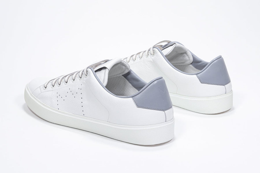 Three quarter back view of low top white sneaker with light grey detailing and perforated crown logo on upper. Full leather upper and white rubber sole.