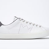 Side profile of low top white sneaker with dark grey detailing and perforated crown logo on upper. Full leather upper and white rubber sole.