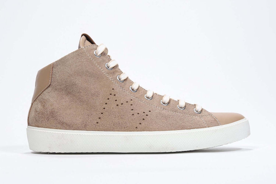 Side profile of mid top cuoio sneaker with full suede upper with perforated crown logo and white sole.