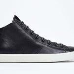 Side profile of mid top black sneaker with full leather upper with perforated crown logo, internal zip and white sole.