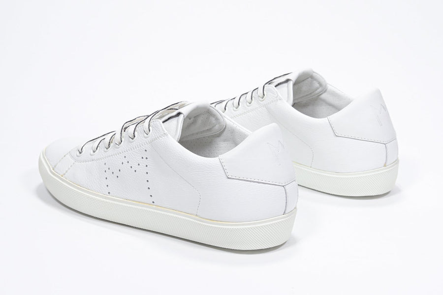 Three quarter back view of low top white sneaker with perforated crown logo on upper. Full leather upper and white rubber sole.