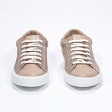 Front view of low top cuoio sneaker with perforated crown logo on upper. Full suede upper and white rubber sole.