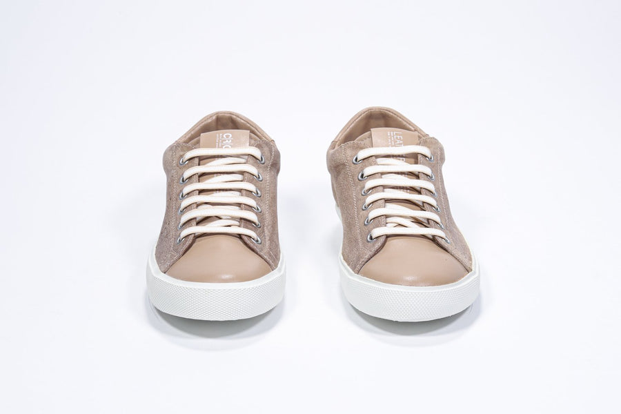 Front view of low top cuoio sneaker with perforated crown logo on upper. Full suede upper and white rubber sole.