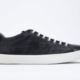 Side profile of low top navy sneaker with perforated crown logo on upper. Full suede upper and white rubber sole.