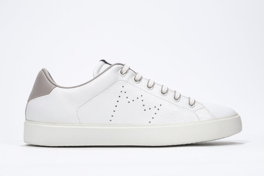 Side profile of low top white sneaker with stone color detailing and perforated crown logo on upper. Full leather upper and white rubber sole.