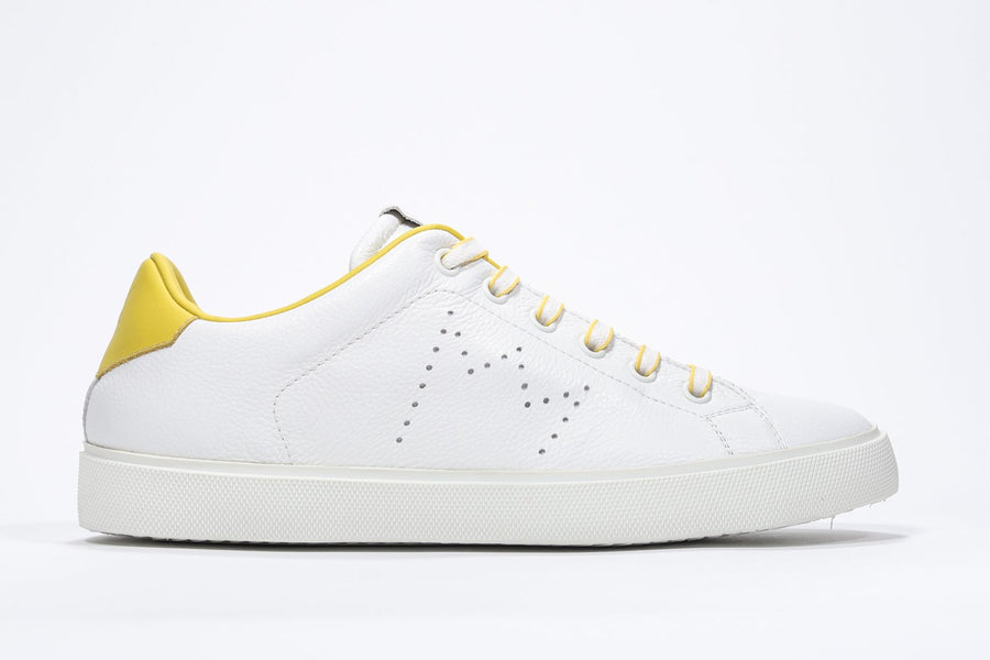 Side profile of low top white sneaker with yellow detailing and perforated crown logo on upper. Full leather upper and white rubber sole.