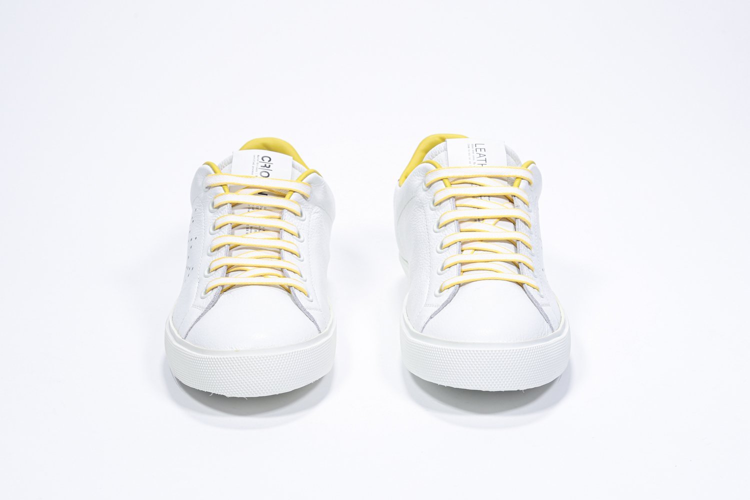 Vorderansicht des weißen Low Top sneaker mit gelben Details und perforiertem Kronenlogo auf dem Obermaterial. Obermaterial aus Vollleder und weiße Gummisohle.