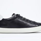 Side profile of low top black sneaker with white detailing and perforated crown logo on upper. Full leather upper and white rubber sole.