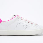 Side profile of low top white sneaker with neon pink detailing and perforated crown logo on upper. Full leather upper and white rubber sole.
