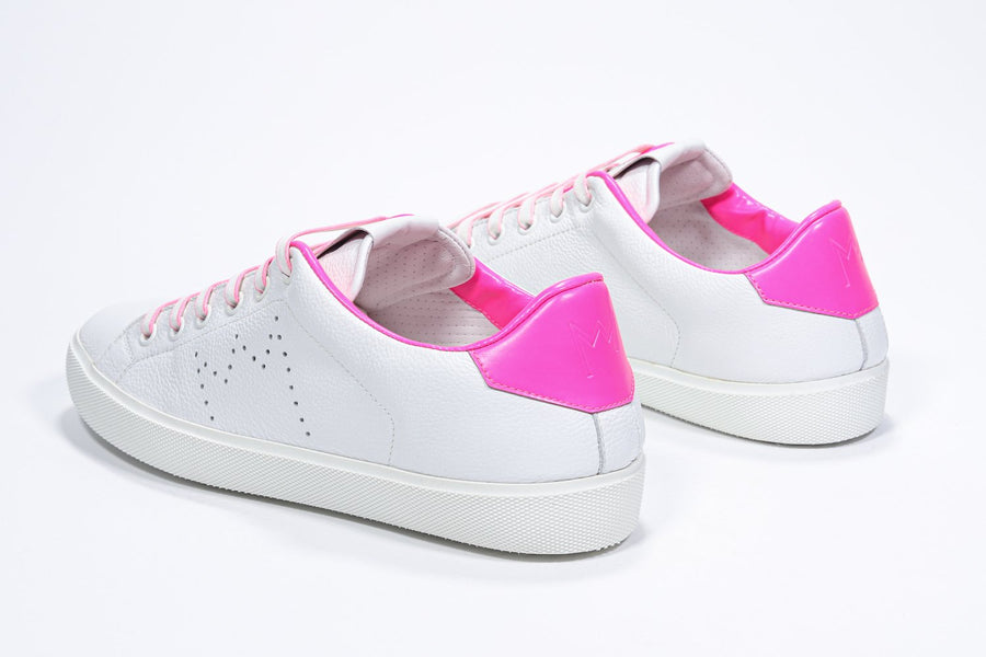 Three quarter back view of low top white sneaker with neon pink detailing and perforated crown logo on upper. Full leather upper and white rubber sole.