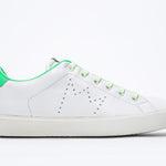 Side profile view of low top white sneaker with neon green detailing and perforated crown logo on upper. Full leather upper and white rubber sole.