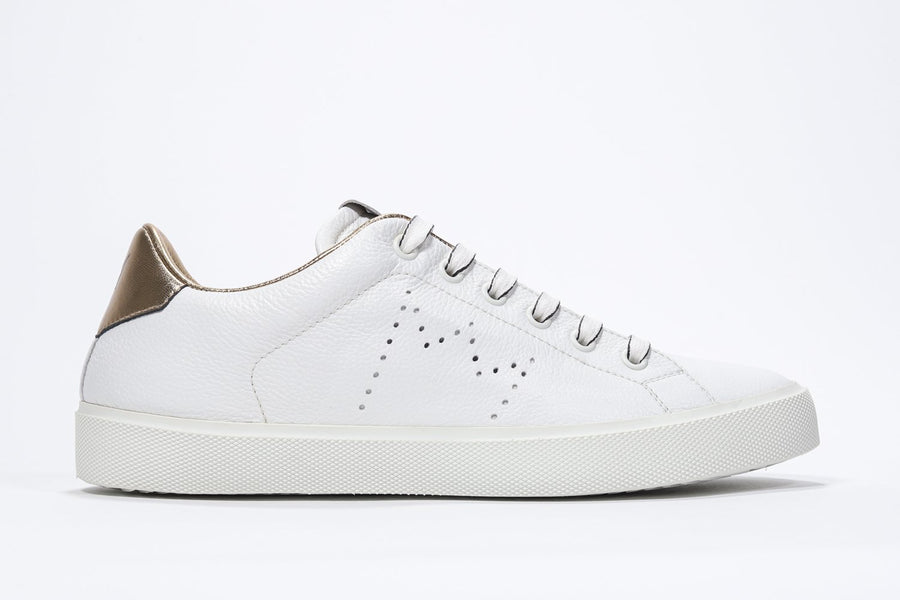 Side profile view of low top white sneaker with gold detailing and perforated crown logo on upper. Full leather upper and white rubber sole.