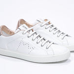 Three quarter front view of low top white sneaker with rose gold metallic detailing and perforated crown logo on upper. Full leather upper and white rubber sole.