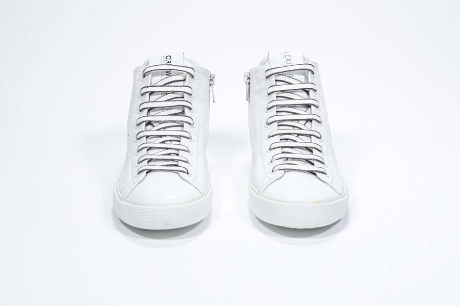 Front view of mid top white sneaker with full leather upper with perforated crown logo, internal zip and white sole.