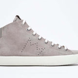 Side profile of mid top beige sneaker with full suede upper with perforated crown logo, internal zip and white sole.