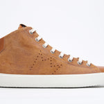 Side profile of mid top rust sneaker with full suede upper with perforated crown logo, internal zip and white sole.