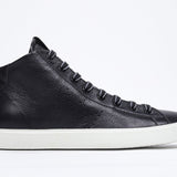 Side profile of mid top black sneaker with full leather upper with perforated crown logo, internal zip and white sole.