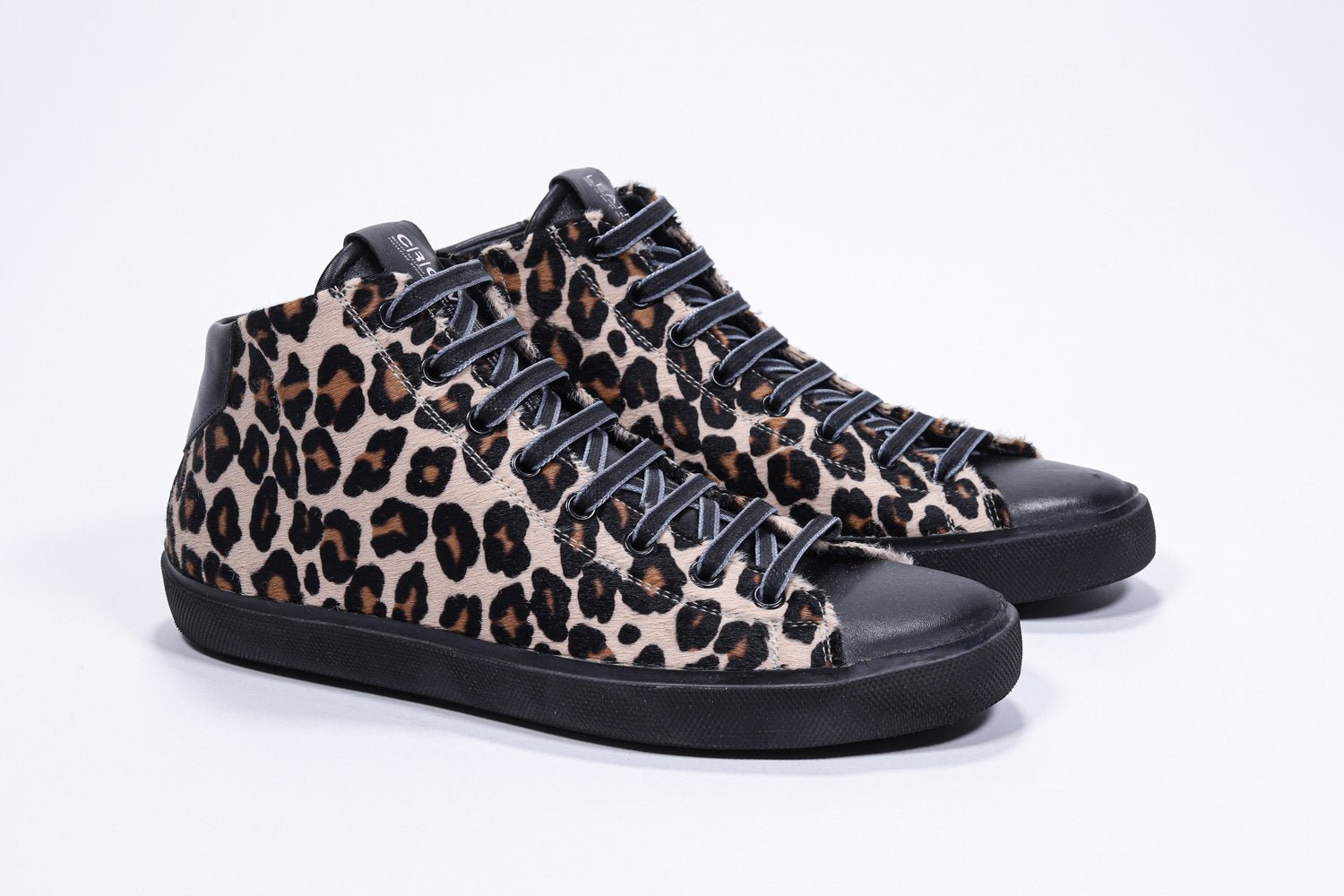 Vue de trois quarts avant d'un modèle intermédiaire sneaker à imprimé léopard, avec tige en cuir de veau pleine fleur, fermeture à glissière interne et semelle noire.