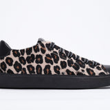 Side profile of low top leopard print sneaker. Full haircalf leather upper and black rubber sole.