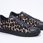 Vue de trois quarts avant de la chaussure à imprimé léopard sneaker. Tige en cuir pleine fleur et semelle en caoutchouc noir.