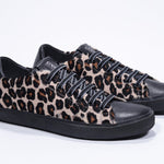 Three quarter front view of low top leopard print sneaker. Full haircalf leather upper and black rubber sole.