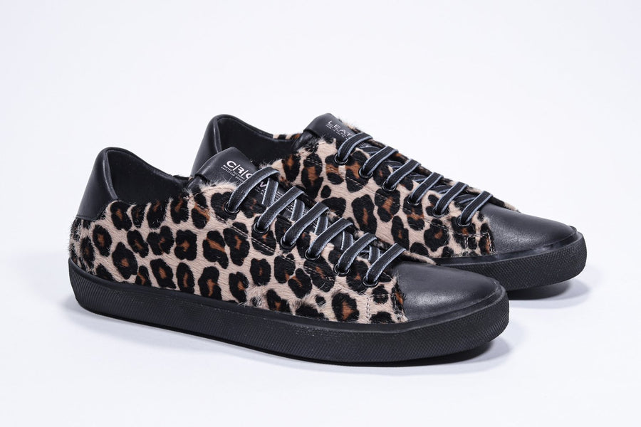 Three quarter front view of low top leopard print sneaker. Full haircalf leather upper and black rubber sole.