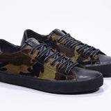 Three quarter front view of low top camouflage print sneaker. Full haircalf leather upper and black rubber sole.
