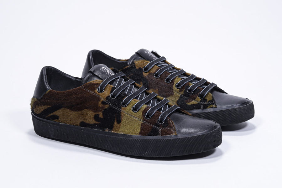 Three quarter front view of low top camouflage print sneaker. Full haircalf leather upper and black rubber sole.