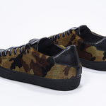 Three quarter back view of low top camouflage print sneaker. Full haircalf leather upper and black rubber sole.