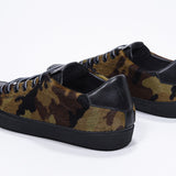 Three quarter back view of low top camouflage print sneaker. Full haircalf leather upper and black rubber sole.