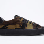 Side profile of low top camouflage print sneaker. Full haircalf leather upper and black rubber sole.
