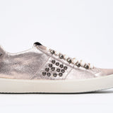 Side profile of low top metallic rose sneaker. Full leather upper with studs and vintage rubber sole.