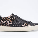 Side profile of low top leopard print sneaker. Full haircalf and leather upper with studs and vintage rubber sole.
