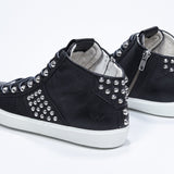 Three quarter back view of mid top black sneaker. Full leather upper with studs, an internal zip and white rubber sole.