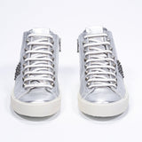 Front view of mid top metallic silver sneaker. Full leather upper with studs, an internal zip and vintage rubber sole.
