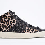 Side profile of mid top leopard print sneaker. Haircalf and leather upper with studs, an internal zip and vintage rubber sole.