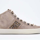Side profile of mid top cuoio color sneaker. Full suede upper with studs, an internal zip and vintage rubber sole.