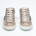 Front view of mid top cuoio color sneaker. Full suede upper with studs, an internal zip and vintage rubber sole.