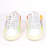 Front view of low top sneaker. Patchwork upper of mixed materials and silver studs.