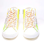 Front view of mid top sneaker. Patchwork upper of mixed materials and silver studs.