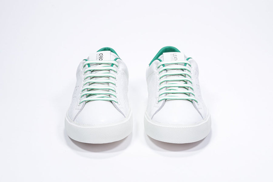 Vorderansicht eines weißen Low-Top-Sneakers mit grünen Details und perforiertem Kronenlogo auf dem Obermaterial. Obermaterial aus Vollleder und weiße Gummisohle.